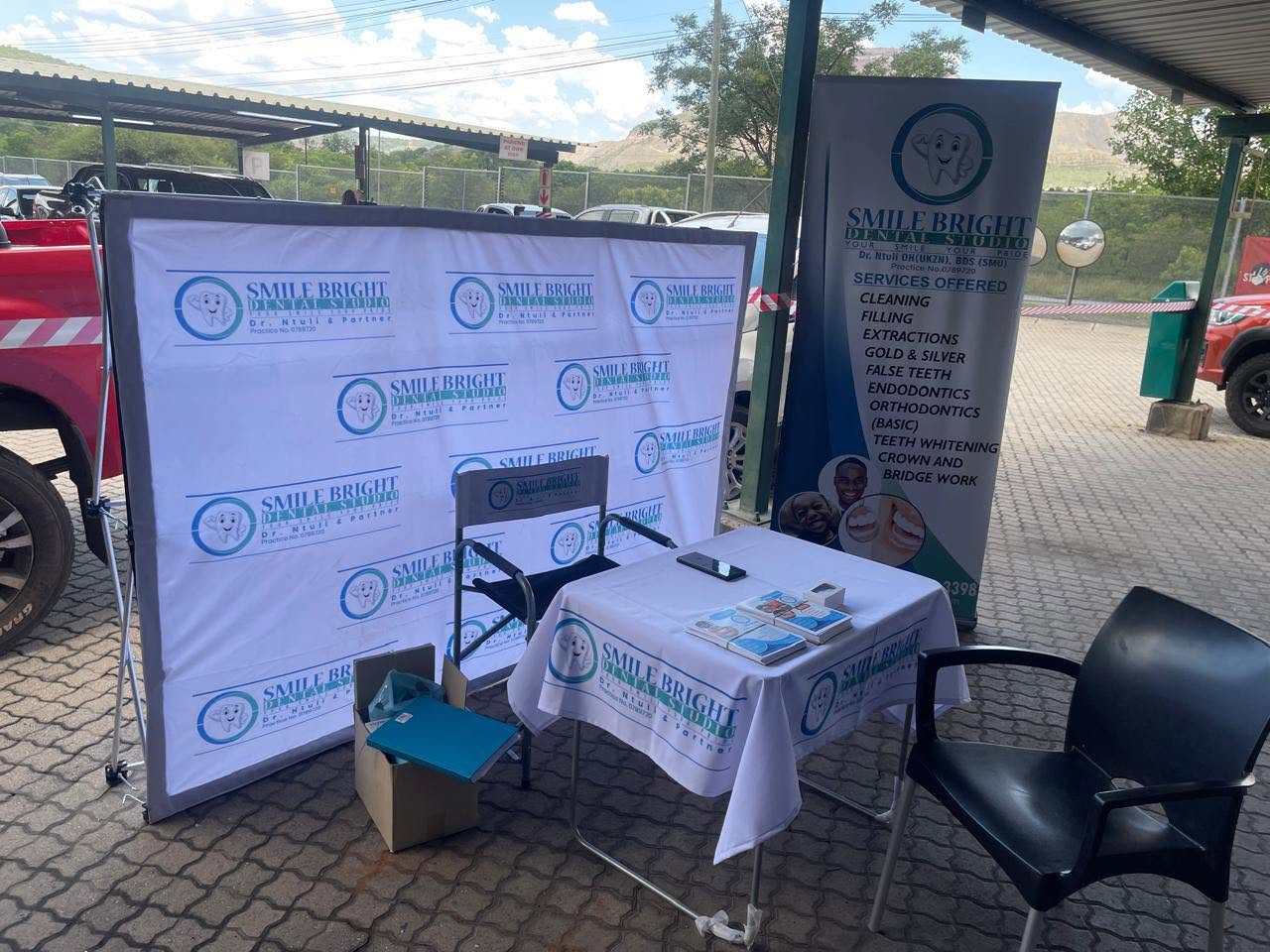 Smile Bright Dental Studio branded stand at a community outreach day